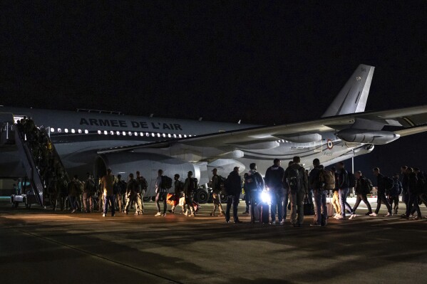 This photo provided Friday May 17, 2024 by the French Army shows security force embarking a plane to New Caledonia, Thursday, May 16, 2024 at the Istres military base, southern France. The number of violent incidents reported in the French Pacific territory of New Caledonia fell slightly on Friday, a day after France imposed a state of emergency as 1,000 promised reinforcements for security services were deployed with increased powers to quell unrest in the archipelago that has long sought independence. (Etat Major des Armees via AP)