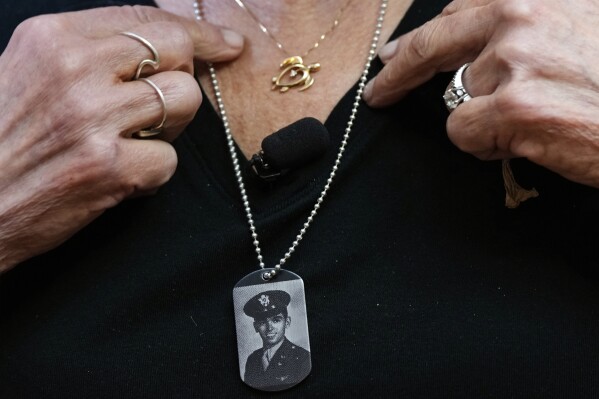 Diane Christie wears a necklace with a photograph of her uncle, World War II U.S. Army Air Forces 2nd Lt. Thomas Kelly, inside Santos Robinson Mortuary, Friday, May 23, 2025, in San Leandro, Calif., whose remains had been missing since being killed when the World War II bomber nicknamed Heaven Can Wait was hit by anti-aircraft fire and crashed into the water off the coast of New Guinea on March 11, 1944. (AP Photo/Godofredo A. Vásquez)