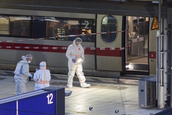 Investigators work at Hamburg, Germany's Central Station on Friday, May 23, 2025, after several people were injured in a knife attack. (Georg Wendt/dpa via AP)