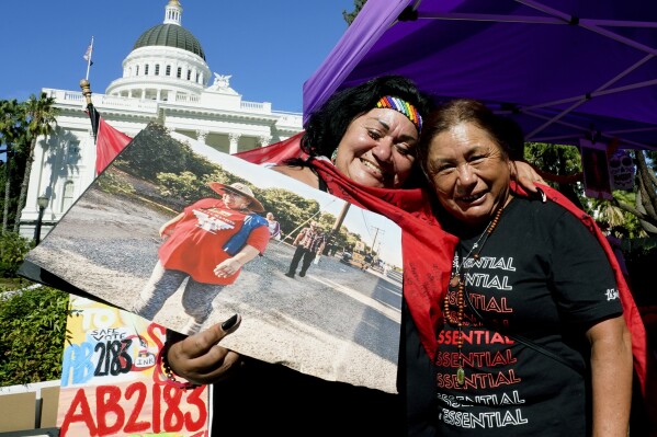 FILE - Farmworkers Cynthia Burgos, left and Teresa Maldonado, right, hug after Gov. Gavin Newsom signed a bill aimed at making it easier for farmworkers to unionize in Sacramento, Calif., Sept. 28, 2022. A battle between The Wonderful Co. which grows pistachios, pomegranates, citrus and other crops and United Farm Workers is over new rules in California aimed at making it easier for farmworkers to form unions. (AP Photo/Rich Pedroncelli, File)