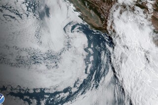 This Saturday, Aug. 19, 2023 11:38 a.m. EDT satellite image provided by the National Oceanic and Atmospheric Administration shows Hurricane Hilary, right, off Mexico’s Pacific coast. Hurricane Hilary headed for Mexico's Baja California on Saturday as the U.S. National Hurricane Center predicted “catastrophic and life-threatening flooding” for the peninsula and for the southwestern United States, where it was forecast to cross the border as a tropical storm on Sunday. (NOAA via AP)