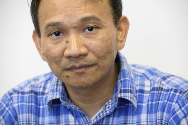 Vuthy Tha, a Cambodian reporter at Radio Free Asia who spent 7 years in a Thai refugee camp before arriving in the United States, poses for a portrait, Tuesday, April 1, 2025, at the RFA office in Washington. (AP Photo/Rod Lamkey, Jr.)