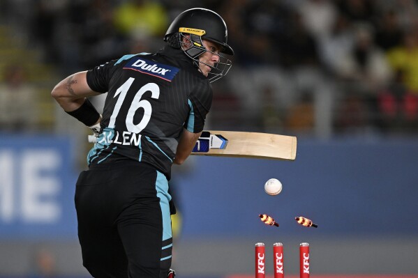 New Zealand's Finn Allen is bowled by Josh Hazelwood during the T20 cricket international between Australia and New Zealand at Eden Park in Auckland, New Zealand, Friday, Feb. 23, 2024. (Andrew Cornaga/Photosport via AP)