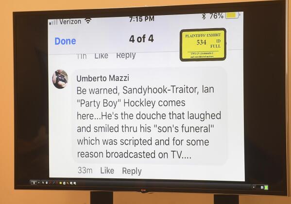 An online post targeting Ian Hockley, father of deceased Sandy Hook student Dylan Hockley, is displayed to the jury panel during the Alex Jones defamation trial at Superior Court in Waterbury, Conn. on Tuesday, Sept. 27, 2022. (Brian A. Pounds/Hearst Connecticut Media via AP)