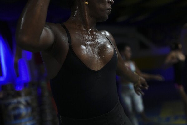Transgender woman Negriny Venture rehearses at the Paraiso de Tuiuti samba school for the Carnival parade in Rio de Janeiro, Wednesday, Feb. 5, 2025. (AP Photo/Silvia Izquierdo)
