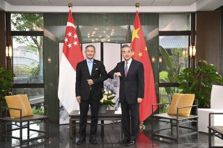 In this photo released by Xinhua News Agency, Chinese Foreign Minister Wang Yi, right, bumps elbows with Singaporean Foreign Minister Vivian Balakrishnan in Nanping City, southeast China's Fujian Province Thursday, March 31, 2021. The Chinese Foreign Minister is meeting with his counterparts from four Asian countries including Singapore, Malaysia, Indonesia and Philippine in southeastern China. (Li Xiang/Xinhua via AP)