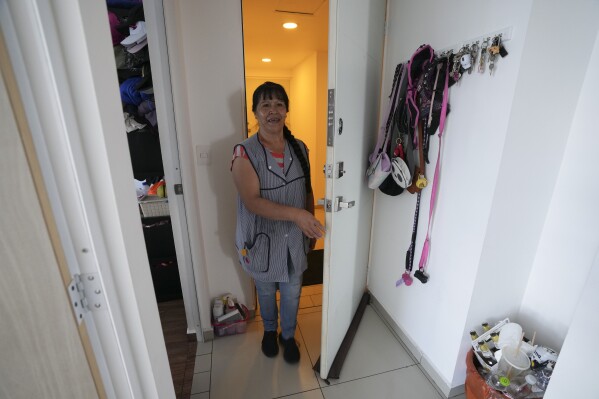 Domestic worker Gabriela Flores arrives to work in Mexico City, Sunday, May 19, 2024. Flores is among approximately 2.5 million Mexicans — largely women — who serve as domestic workers in the Latin American nation. (AP Photo/Marco Ugarte)