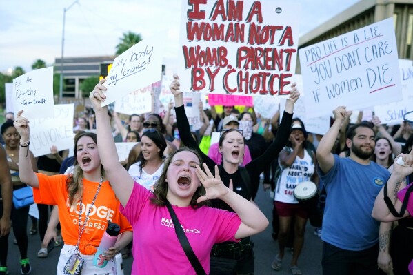 FILE - Protesters in Phoenix shout as they join thousands marching around the Arizona state Capitol after the U.S. Supreme Court decision to overturn the landmark Roe v. Wade abortion decision on June 24, 2022. A stunning abortion ruling this week in April 2024, has supercharged Arizona’s role in the looming fall election. (AP Photo/Ross D. Franklin, File)