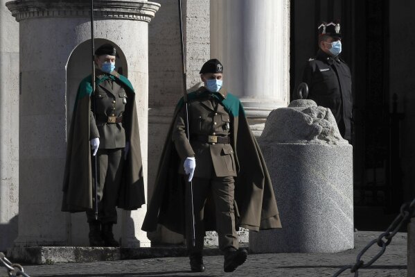 The change of the guards at the entrance of the Rome's Quirinale Presidential Palace, Tuesday, Jan. 26, 2021. Premier Giuseppe Conte was meeting Tuesday, with his cabinet before heading to the presidential palace to offer his resignation after a key coalition ally pulled his party's support over Conte's handling of the coronavirus pandemic. (AP Photo/Alessandra Tarantino)