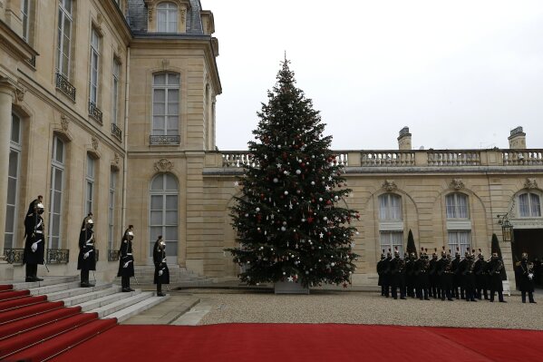 A Christmas tree is pictured in the courtyard of the Elysee palace before Egyptian President Abdel-Fattah el-Sissi's arrival, Monday, Dec. 7, 2020 in Paris. Egyptian President Abdel-Fattah el-Sissi is paying a state visit to France for talks on fighting terrorism, the conflict in Libya and other regional issues, amid criticism from human rights groups over the Egyptian leader's crackdown on dissent. (AP Photo/Michel Euler)