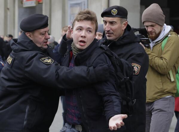 FILE - Belarus police arrest journalist Raman Pratasevich, center, in Minsk, Belarus, Sunday, March 26, 2017. A Belarusian court has convicted a dissident journalist who was arrested after being pulled off a commercial flight that was diverted to the country. The court sentenced Raman Pratasevich to eight years in prison on Wednesday. (AP Photo, File)