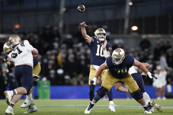 Notre Dame quarterback Sam Hartman (10) throws against Navy during an NCAA college football game in Dublin, Ireland, Aug. 26, 2023. (AP Photo/Peter Morrison)