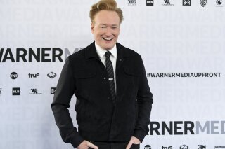FILE - In this May 15, 2019 file photo shows late night talk show host Conan O'Brien at the WarnerMedia Upfront in New York. O'Brien said he will resume putting out new episodes of TBS' “Conan” on March 30. His staff will remain at home, and the show will be cobbled together with O'Brien on an iPhone and guests via Skype. (Photo by Evan Agostini/Invision/AP, File)