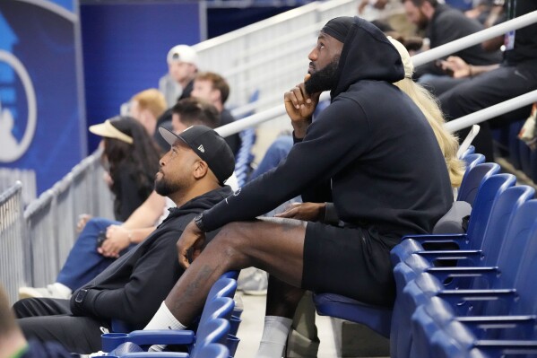 Los Angeles Lakers' LeBron James watches his son Bronny James during the 2024 NBA Draft Combine 5-on-5 basketball game between TeamSt. Andrews and Team Love in Chicago, Wednesday, May 15, 2024. (AP Photo/Nam Y. Huh)