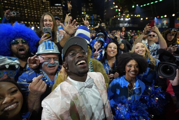 Alabama cornerback Terrion Arnold celebrates with fans after being chosen by the Detroit Lions with the 24th overall pick during the first round of the NFL football draft, Thursday, April 25, 2024, in Detroit. (AP Photo/Paul Sancya)
