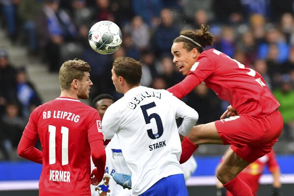 Leipzig's Yussuf Poulsen, right, Timo Werner, left, and and Berlin's Niklas Stark, center, challenge for the ball during the Bundesliga soccer match between Hertha BSC Berlin and RB Leipzig in Berlin, Germany, Saturday, Nov. 9, 2019. (Soeren Stache/dpa via AP)