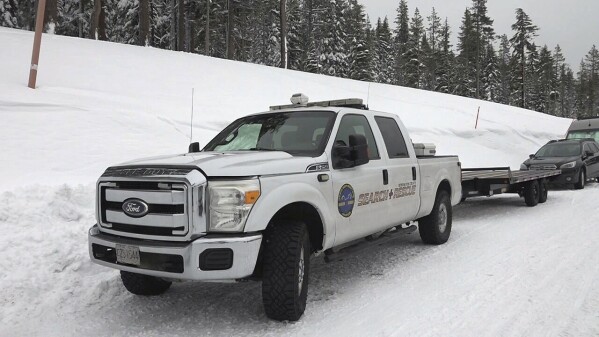 In this still image from video, a Deschutes County Sheriff's Office search-and-rescue vehicle is seen near Dutchman Flat in the Oregon Cascade Mountains northeast of Mount Bachelor, Ore., on Tuesday, Feb. 18, 2025, after a deadly avalanche on Monday. (Central Oregon Daily News via AP)