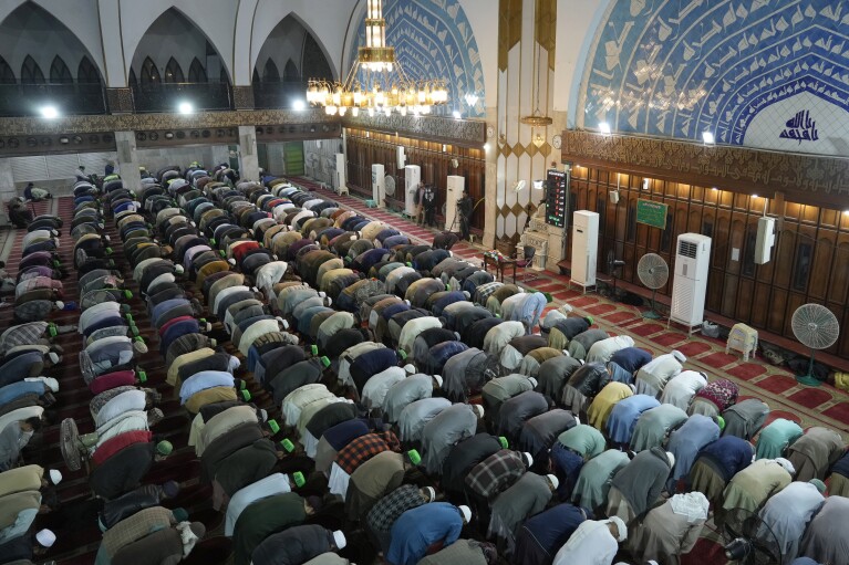 Muslims perform a special prayer called 'Tarawih' at Data Darbar mosque on the start of Muslim fasting month of Ramadan, in Lahore, Pakistan, Monday, March 11, 2024. (AP Photo/K.M. Chaudary)