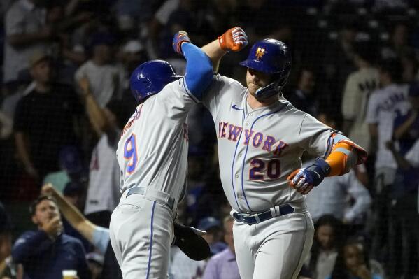 New York Mets' Pete Alonso (20) and Brandon Nimmo celebrate after they scored on Alonso's two-run home run off Chicago Cubs relief pitcher Mark Leiter Jr. during the eighth inning of a baseball game Thursday, July 14, 2022, in Chicago. (AP Photo/Charles Rex Arbogast)
