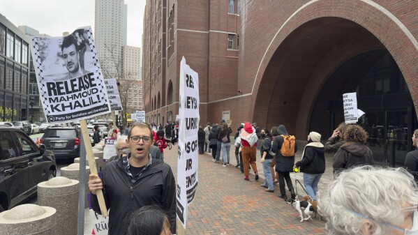 Protesters gather outside federal court during a hearing with lawyers for Rumeysa Ozturk, a Tufts University doctoral student from Turkey who was detained by immigration authorities, Thursday, April 3, 2025 in Boston. (AP Photo/Rodrique Ngowi)
