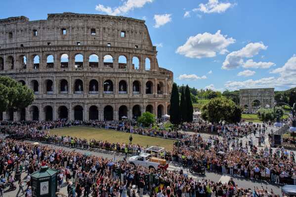 The coffin of Pope Francis passes the Colosseum in Rome, Saturday, April 26, 2025. (AP Photo/Bernat Armangue)