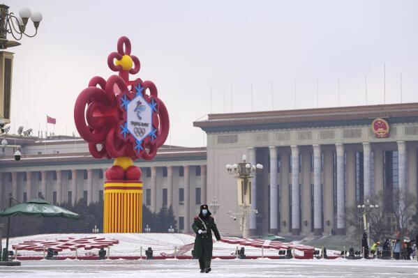 A paramilitary police officer wearing a face mask marches past a decoration for the Beijing Winter Olympics Games in front of the Great Hall of the People on Tiananmen Square in Beijing on Jan. 20, 2022. The just-concluded Winter Olympics weren’t China's big event of the year, internally, at least. For the Communist Party, that comes this fall at a major meeting that will likely cement Xi Jinping's position as one of the nation's most powerful leaders in its seven decades of Communist rule. (AP Photo/Andy Wong)