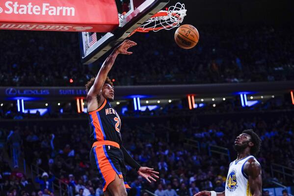 New York Knicks' Miles McBride (2) dunks the ball in front of Golden State Warriors' James Wiseman (33) during the second half of an NBA basketball game Tuesday, Dec. 20, 2022, in New York. The Knicks won 132-94. (AP Photo/Frank Franklin II)
