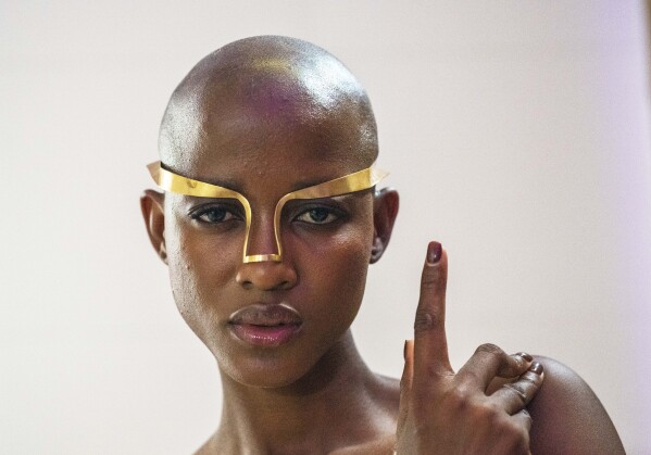 A model poses backstage wearing jewellery designed for Niger's designer Alia Bare's show during Johannesburg Fashion Week 2023 in Johannesburg, South Africa, Thursday, Nov. 9, 2023. (AP Photo/Jerome Delay)