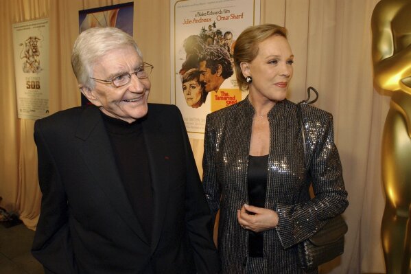 FILE - This Feb. 26, 2004 file photo shows director Blake Edwards, left, and his wife Julie Andrews as they arrive for a special reception for Edwards, who will receive an Honorary Oscar at the 76th Academy Awards ceremony, in the Hollywood section of Los Angeles. Andrews released a memoir, “Home Work: A Memoir of My Hollywood Years,” which hits shelves on Oct. 15, 2019. (AP Photo/Rene Macura, File)