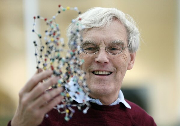 Richard Henderson, one of the 2017 Nobel Prize winners in Chemistry, holds a bacterio rhodopsin model prior to a press conference at the Laboratory of Molecular Biology in Cambridge, England, Wednesday, Oct. 4, 2017. Three researchers based in the U.S., U.K. and Switzerland won the Nobel Prize in Chemistry on Wednesday for developments in electron microscopy. The 9-million-kronor ($1.1 million) prize is shared by Jacques Dubochet of the University of Lausanne, Joachim Frank at New York's Columbia University and Richard Henderson of MRC Laboratory of Molecular Biology in Cambridge, Britain. (AP Photo/Frank Augstein)
