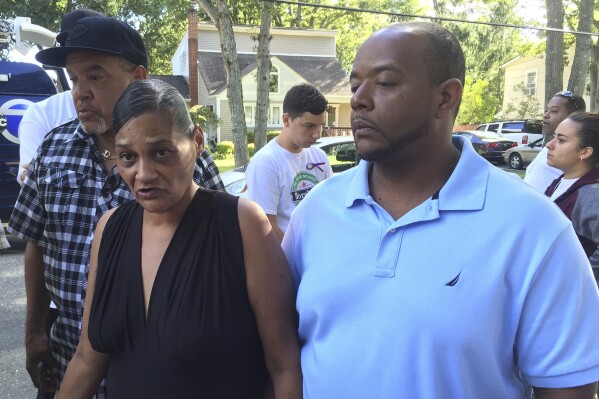 FILE - Elizabeth Alvarado, left, and Rob Mickens speak with reporters, Sept. 15, 2016, at the scene where their teenage daughter, Nisa Mickens, and Kayla Cuevas were found dead in Brentwood, N.Y. A member of the violent MS-13 street gang pleaded guilty Thursday, Aug. 31, 2023, for his part in the murders of four people, including the two teenage girls who were attacked with a machete and baseball bats as they walked through their suburban Long Island neighborhood seven years ago. (AP Photo/Mike Balsamo, File)