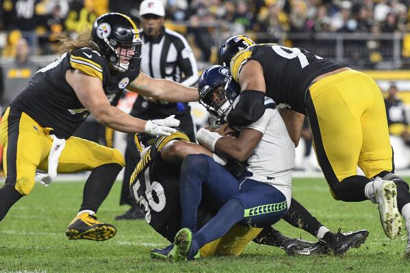 Seattle Seahawks quarterback Geno Smith (7) is sacked by Pittsburgh Steelers outside linebacker Alex Highsmith (56), defensive end Henry Mondeaux (99), left, and defensive end Chris Wormley (95), right, during the second half an NFL football game, Sunday, Oct. 17, 2021, in Pittsburgh. (AP Photo/Don Wright)