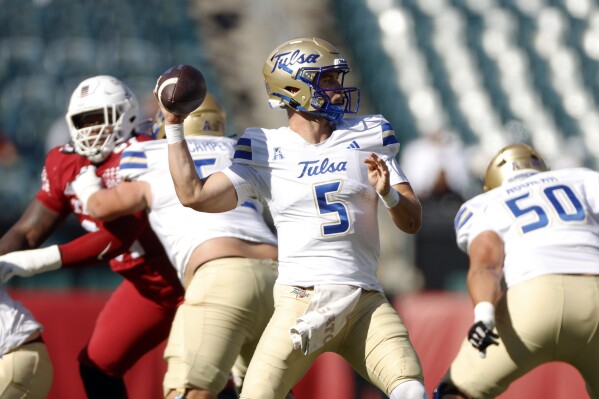 FILE - Tulsa quarterback Cooper Legas looks for an open receiver while facing Temple during an NCAA football game on Saturday, Oct. 19, 2024, in Philadelphia. (AP Photo/Jason E. Miczek, File)