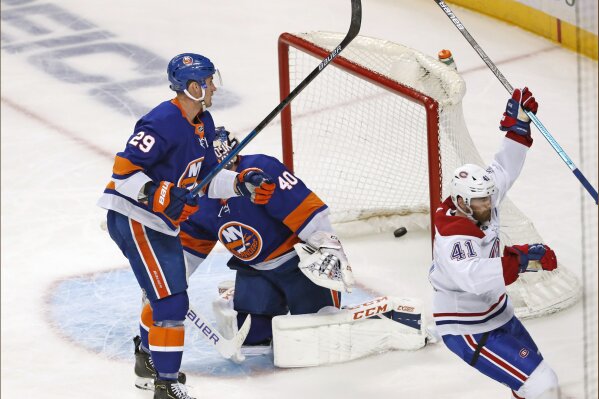 Montreal Canadiens left wing Paul Byron (41) celebrates after scoring a goal against New York Islanders goaltender Semyon Varlamov (40), as Islanders center Brock Nelson (29) skates past Varlamov during the second period of an NHL hockey game Tuesday, March 3, 2020, in New York. (AP Photo/Kathy Willens)