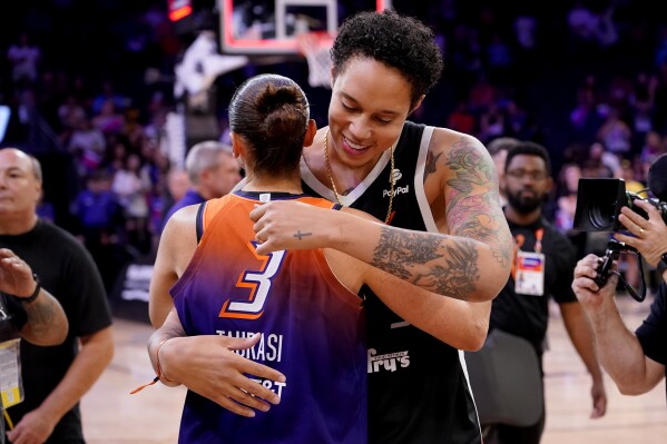 FILE - Phoenix Mercury guard Diana Taurasi (3) hugs Brittney Griner after the team's WNBA basketball game against the Atlanta Dream, Aug. 3, 2023, in Phoenix. Griner’s return to the WNBA after nearly 10 months in a Russian prison hasn’t always been the smoothest ride. There have been injuries. There was a break for mental health. But there have also been many moments of joy. She was welcomed by adoring crowds at nearly every WNBA arena. Individually, she played well, and was selected to play in another All-Star game. (AP Photo/Matt York, File)