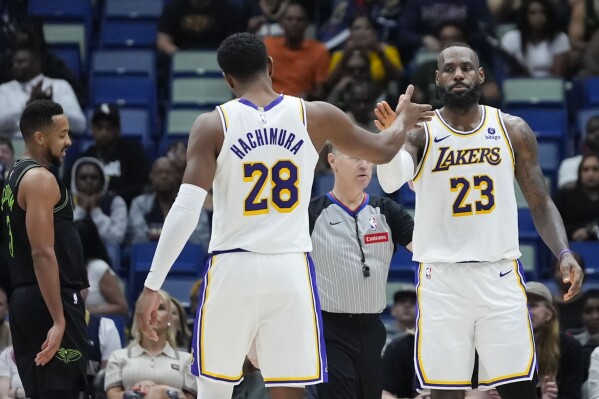 Los Angeles Lakers forward LeBron James (23) celebrates with forward Rui Hachimura (28) after being fouled in the second half of an NBA basketball game against the New Orleans Pelicans in New Orleans, Sunday, April 14, 2024. The Lakers won 124-108. (AP Photo/Gerald Herbert)