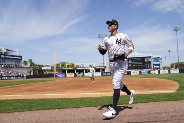 New York Yankees center fielder Aaron Judge runs to the dugout in the third inning of a spring training baseball game against the Atlanta Braves Sunday, March 10, 2024, in Tampa, Fla. (AP Photo/Charlie Neibergall)