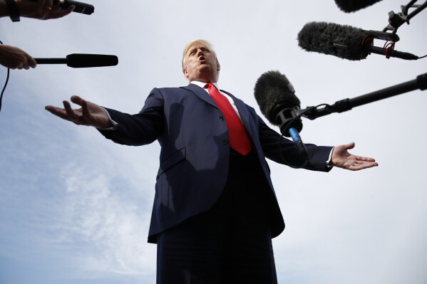 President Donald Trump speaks with reporters before boarding Air Force One in Morristown, N.J., Aug. 15, 2019. (AP Photo/Patrick Semansky)