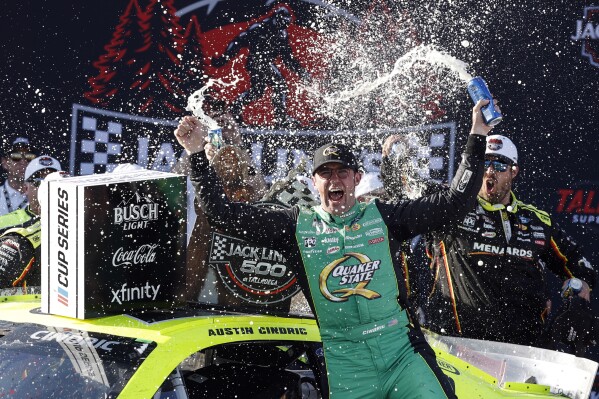 NASCAR Cup Series driver Austin Cindric celebrates after winning a NASCAR Cup Series auto race at Talladega Superspeedway, Sunday, April 27, 2025, in Talladega, Ala. (AP Photo/Butch Dill)
