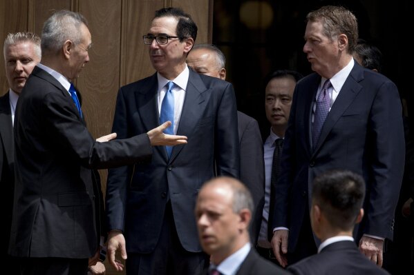 
              Treasury Secretary Steve Mnuchin, second from left, and United States Trade Representative Robert Lighthizer, right, speak with Chinese Vice Premier Liu He, left, as he departs the Office of the United States Trade Representative in Washington, Friday, May 10, 2019. (AP Photo/Andrew Harnik)
            