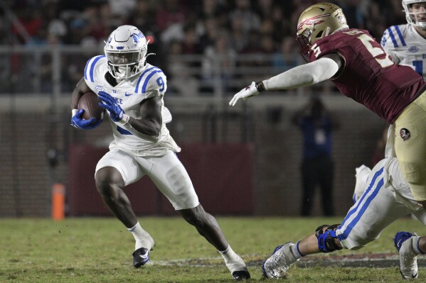 Duke running back Jaquez Moore (9) rushes for yardage in front of Florida State defensive lineman Jared Verse (5) during the first half of an NCAA college football game, Saturday, Oct. 21, 2023, in Tallahassee, Fla. (AP Photo/Phelan M. Ebenhack)