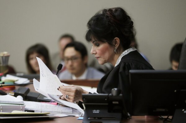 
              Judge Rosemarie Aquilina reads excerpts from the letter written by Larry Nassar during the seventh day of Nassar's sentencing hearing Wednesday, Jan. 24, 2018, in Lansing, Mich.  The former sports doctor who admitted molesting some of the nation's top gymnasts for years was sentenced Wednesday to 40 to 175 years in prison as Aquilina declared: "I just signed your death warrant."  The sentence capped a remarkable seven-day hearing in which scores of Larry Nassar's victims were able to confront him face to face in a Michigan courtroom. (AP Photo/Carlos Osorio)
            