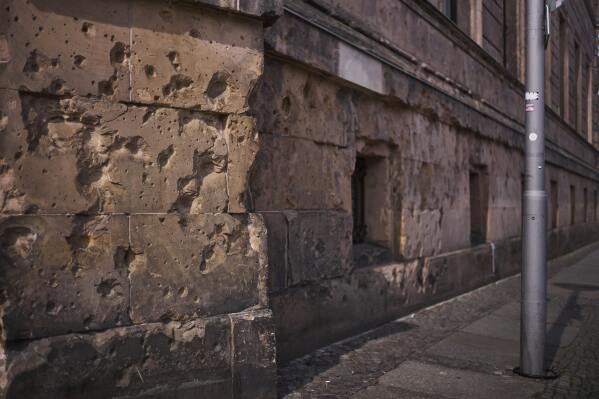 Eighty years after the end of World War II, holes from artillery fire are still visible on the facade of a house in the city center of Berlin, Germany, Friday, May 2, 2025. (AP Photo/Markus Schreiber)