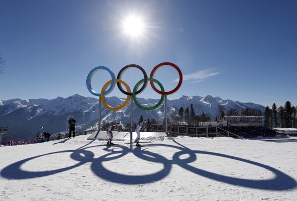 FILE - Sweden's Charlotte Kalla leads Norway's Marit Bjoergen in women's cross country at the 2014 Winter Olympics, in Krasnaya Polyana, Russia, on Saturday, Feb. 8, 2014. When Russia hosted the 2014 Winter Games in Sochi, it sought to impress the world and expand its global prestige with the most expensive Olympics ever. (AP Photo/Felipe Dana, File)