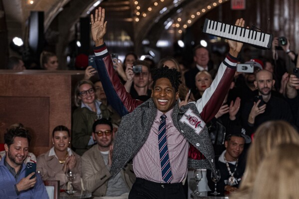 Musician Jon Batiste, center, performs at the Tommy Hilfiger runway show during Fashion Week, Friday, Feb. 9, 2024, in New York. (AP Photo/Peter K. Afriyie)