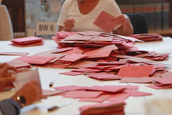 A view of a pile of ballot papers during the counting of the postal vote at the Bürgerhaus Nordhausen polling station, Germany, Sunday, Sept. 24, 2023. The German city of Nordhausen is best known as the location of the former Nazi concentration camp Mittelbau-Dora. On Sunday, a mayoral election could again put the focus on the municipality of 42,000 people if a far-right candidate wins the vote.Joerg Prophet, a candidate from the populist far-right Alternative for Germany party, or AfD, is the frontrunner in Sunday’s mayoral runoff vote. (Matthias Bein/dpa via AP)