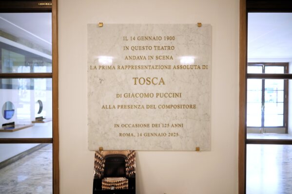 A plate celebrates the 125th anniversary of the first ever performance of Giacomo Puccini's "Tosca" opera in the foyer of the "Teatro dell' Opera" opera house, in Rome, Thursday, April 10, 2025. (AP Photo/Andrew Medichini)