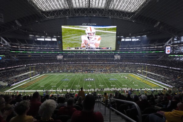 The large video screen shows Iowa State quarterback Rocco Becht (3) as the play Arizona State in the first half of the Big 12 Conference championship NCAA college football game at AT&T Stadium, in Arlington, Texas, Saturday Dec. 7, 2024. (AP Photo/LM Otero)