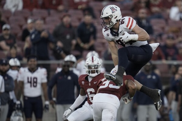 Arizona tight end Tanner McLachlan (84) hurdles Stanford safety Alaka'i Gilman during the second half of an NCAA college football game Saturday, Sept. 23, 2023, in Stanford, Calif. (AP Photo/Godofredo A. Vásquez)