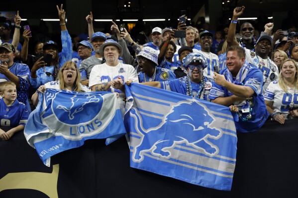 Detroit Lions fans cheer after an NFL football game against the New Orleans Saints, Sunday, Dec. 3, 2023, in New Orleans. Detroit won 33-28. (AP Photo/Butch Dill)